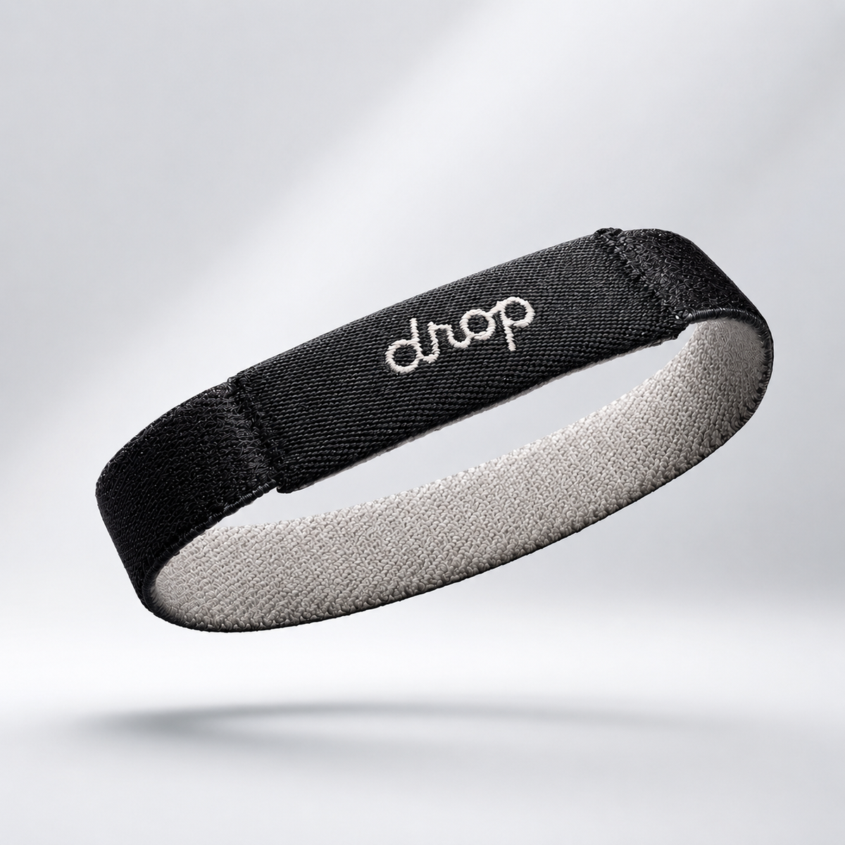 A family walks a boardwalk together, each wearing a Drop Band